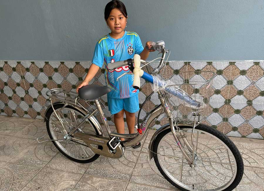 Hang with her new bicycle. Part of the donate a bike to a Vietnamese school child charity.